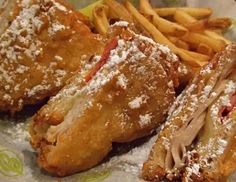 fried chicken and french fries with powdered sugar on top