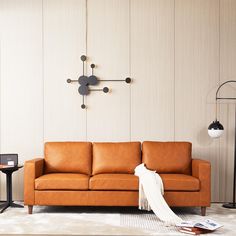 a living room with a couch, table and clock on the wall next to it