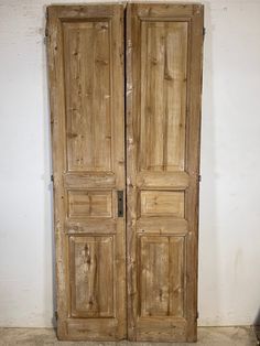 an old pair of wooden doors in a room