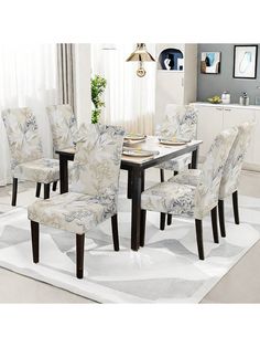 a dining room table with chairs and a rug