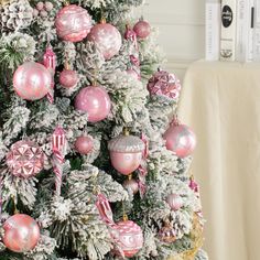 a christmas tree decorated with pink and silver ornaments