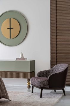 a living room with a chair, table and clock on the wall