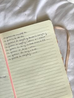 an open notebook sitting on top of a bed