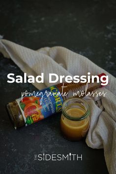 a bottle of salad dressing sitting next to a napkin on top of a black surface