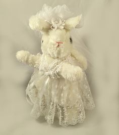 a white stuffed animal wearing a wedding dress