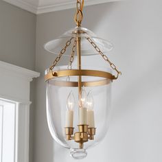 a chandelier with three candles hanging from it