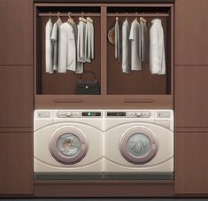 a washer and dryer are in front of some cabinets with clothes hanging on them