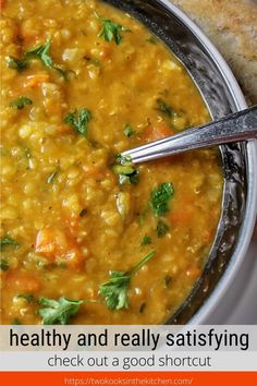 a bowl of soup with bread on the side