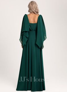 a woman in a long green dress with a backless neckline and open shoulders