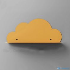 a yellow cloud shaped shelf on a gray wall