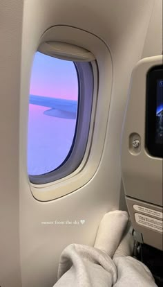 an airplane window looking out at the ocean