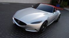 a silver sports car parked in front of a building