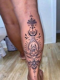 a person with a tattoo on their leg is standing in the middle of the floor