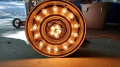 an old wheel with some lights on it