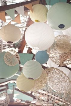 several white and blue paper lanterns hanging from the ceiling