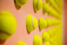 there are many tennis balls on the wall