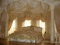 a fancy bedroom with an elaborate bed and chandelier