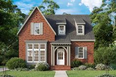 a red brick house with white windows on the front and one story, surrounded by greenery