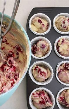 cupcakes with frosting and cranberry topping in muffin tins