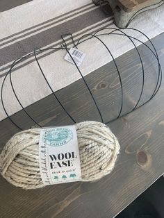 a ball of yarn sitting on top of a wooden table