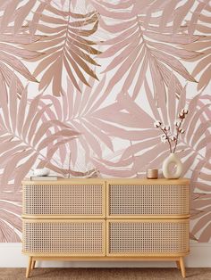 an image of a living room setting with palm leaves on the wall and wicker furniture