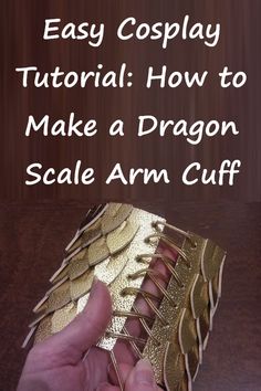 a hand holding a gold dragon scale arm cuff with text overlay that reads easy cosplay tutor how to make a dragon scale arm cuff