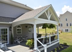 a house with a covered porch and picnic table