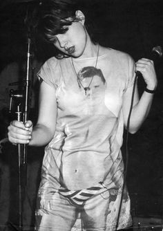 black and white photograph of a woman singing into a microphone