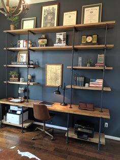 a desk with shelves and pictures on the wall above it, along with a cowhide rug