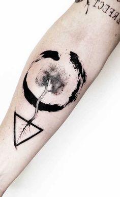 a black and white tattoo on the left arm with an arrow in it's center