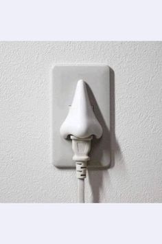 an electric outlet plugged into a wall with a white cord attached to the outlet