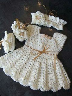 a crocheted baby dress and bonnet with matching booties