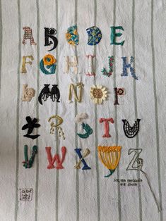 an embroidered piece of cloth with letters and numbers on it