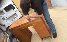 a man working on an old wooden desk