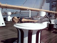 a man laying on the deck of a boat