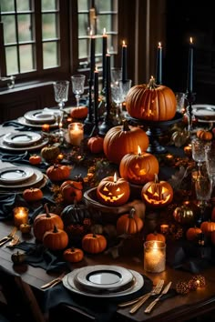 a table set for halloween with pumpkins and candles