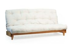 a white futon sofa bed with wooden legs