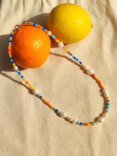 Colourful Pearl Necklace, Casual Orange Beaded Necklaces For Gifts, Playful Summer Beach Necklaces, Playful Summer Beach Necklace, Fun Round Bead Necklaces For Summer, Yellow Beaded Necklaces With Letter Beads For Summer, Fun Summer Necklaces With Round Beads, Handmade Fun Necklaces For Summer, Handmade Playful Summer Necklaces