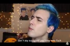 a young man with blue hair is talking to someone