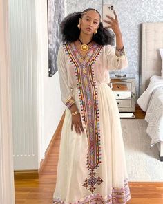 This Habesha Kemis is a true work of art, designed to make you stand out in any crowd. The dress features handwoven Tilf fabric in a beautiful and intricate pattern, adding a touch of elegance and sophistication. The Shimena fabric on the bodice and sleeves is smooth and soft, making it comfortable to wear all day or night. The dress is tailored to fit your body perfectly, with a flowy bottom that adds a touch of grace and femininity. Whether you're attending a wedding, a cultural festival, or a