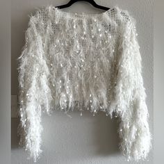 Impressions White Sparkle Stringy Cropped Sweater Size Large Nwt Stay Warm And Stylish For "Fall In Nyc" With This Stunning Ivory Colored Sweater Featuring Lightweight Ultra Fringed Material, A High Rounded Neckline, Long Loose Sleeves With Fitted Cuffs, And A Relaxed Silhouette That Falls Into A Cropped Hemline! Materials Self: 75% Acrylic 15% Nylon 10% Polyester Perfect For Winter Or A Bride Or Some Nye Sparkle! Bachelorette Bridal Winter Party Tops With Feather Trim, White Long Sleeve Party Sweater, Winter Party Top With Feather Trim, White Spring Party Sweater, Sparkle Bachelorette, White Fuzzy Sweater, Sparkle Crop Top, Fall In Nyc, White Sweater Outfit