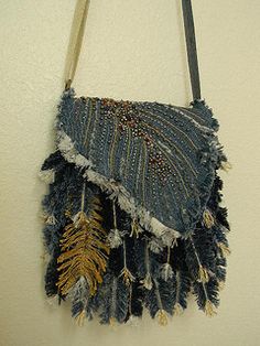 a purse hanging on the wall with fringes and beaded trim around it's edges