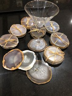 several pieces of glass sitting on top of a table next to plates and bowls with gold ribbons