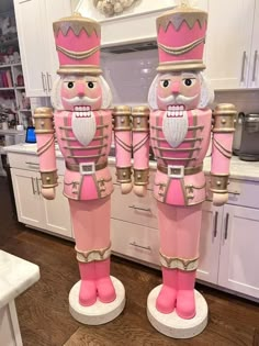 two large pink nutcrackers standing next to each other