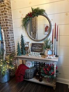 a christmas display with candles, wreaths and other holiday decorations in front of a brick wall