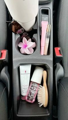 the interior of a car with cosmetics and other items in its holder on the back seat