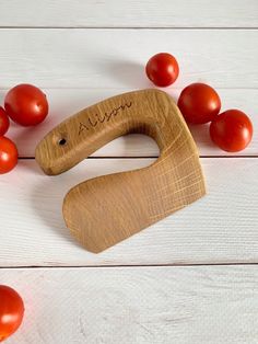 a wooden object with tomatoes around it