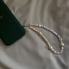 Celebrate elegance and functionality with our Personalized Pearl Phone Strap. Elevate your phone game with this charming accessory that adds a touch of sophistication to your device. Crafted with genuine freshwater pearls and accented with gold detailing, this Pearl Phone Charm doubles as a chic accessory and a practical addition to your phone. Its versatile design makes it perfect for any occasion, whether you're out with friends or attending a special event. Not only does this Pearl Phone Chai Phone Bracelet Pearl, Phone Charms Aesthetic Simple, Pearl Phone Strap, Diy Phone Charm Ideas, Iphone Charms, Pearl Phone Charm, Beaded Phone Charms, Wedding Phone, Phone Chains