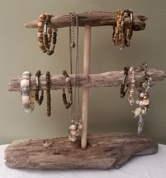 a wooden stand with bracelets and necklaces on it