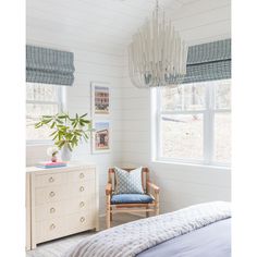 a bedroom with white walls and blue accents